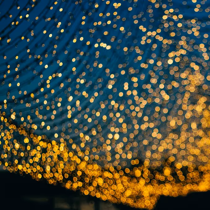 Warm golden bokeh lights against a dark background, evoking elegance and celebration—ideal for perfect event invitation email designs.