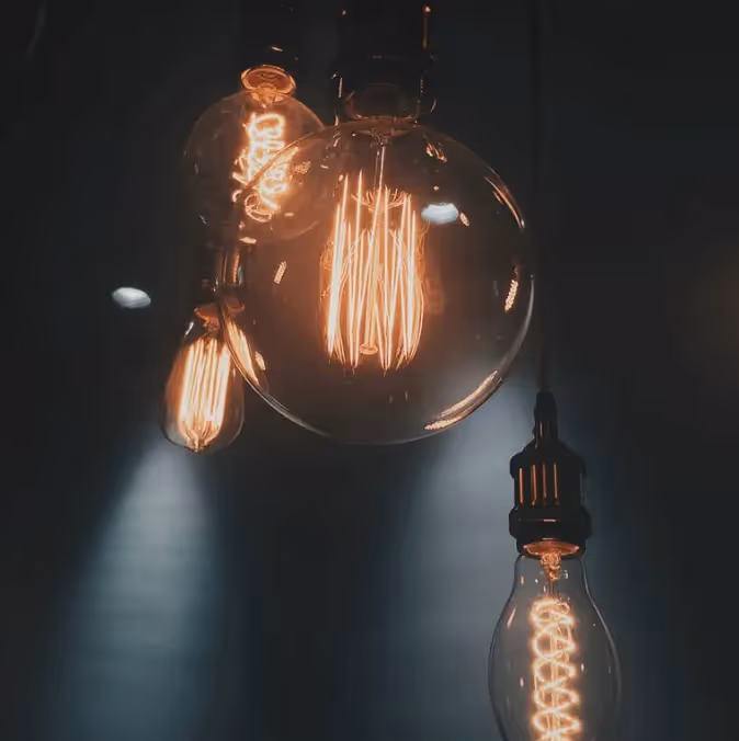 Vintage-style glowing light bulbs in dark setting, symbolizing ideas, learning, and inspiration for online education email campaign visuals.