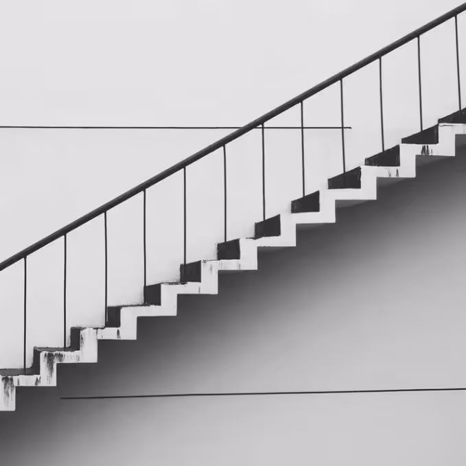 Black and white photo of stairs going up, symbolizing progress and upgrades, representing premium upgrade emails.