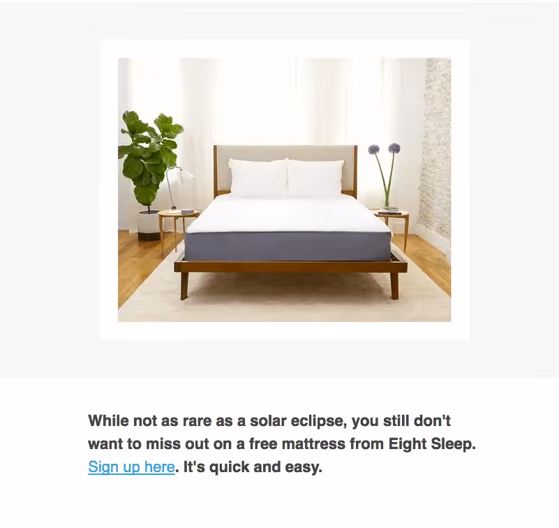 Minimalist bedroom featuring a modern Eight Sleep mattress on a wooden bed frame, used in a free giveaway promotion.