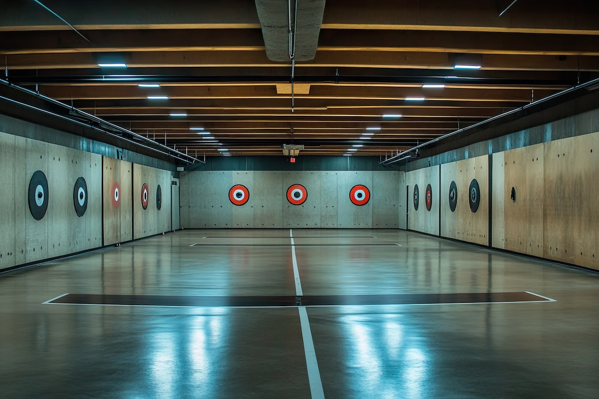 Empty gun range with targets on the walls. The floor is laquered and polished.