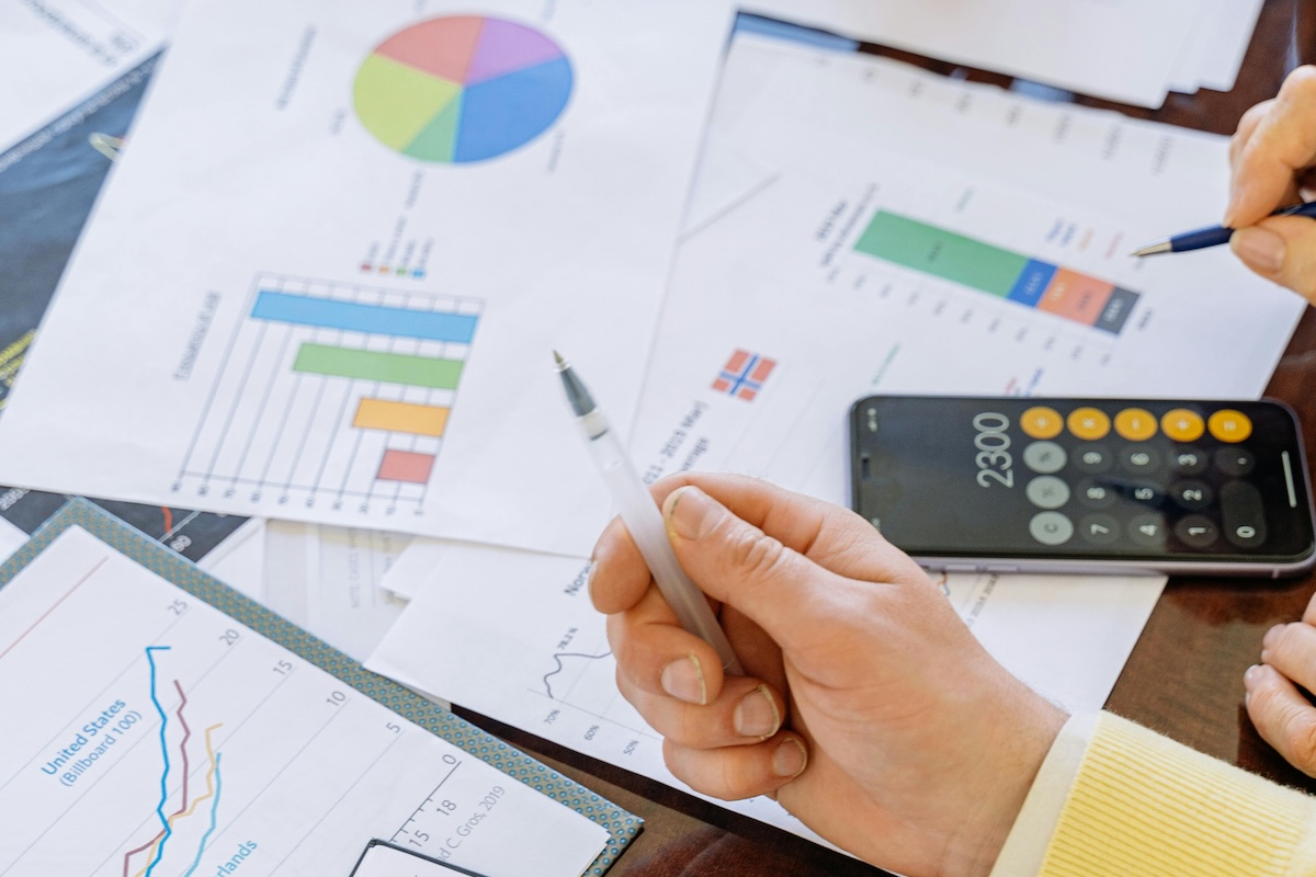 An insurance agent and a client review charts and documents regarding Commercial General Liability Insurance.