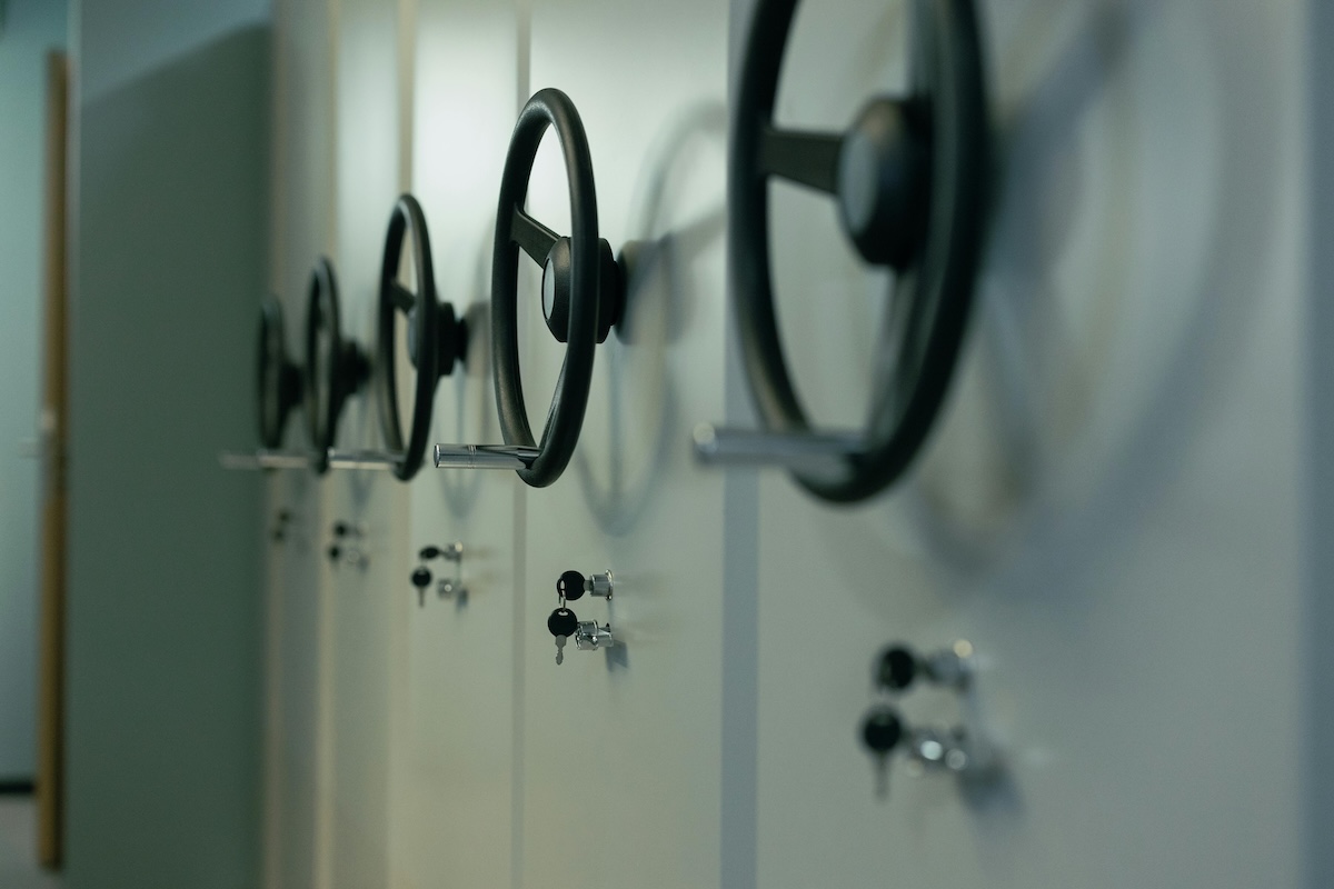 Close-up of industrial safes with manual locks and keys for firearms, highlighting security features.