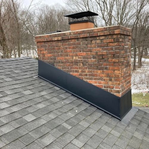 Completed asphalt shingle roof with custom chimney wrap by Northrup's Roofing & Restoration in Milwaukee, Wisconsin.