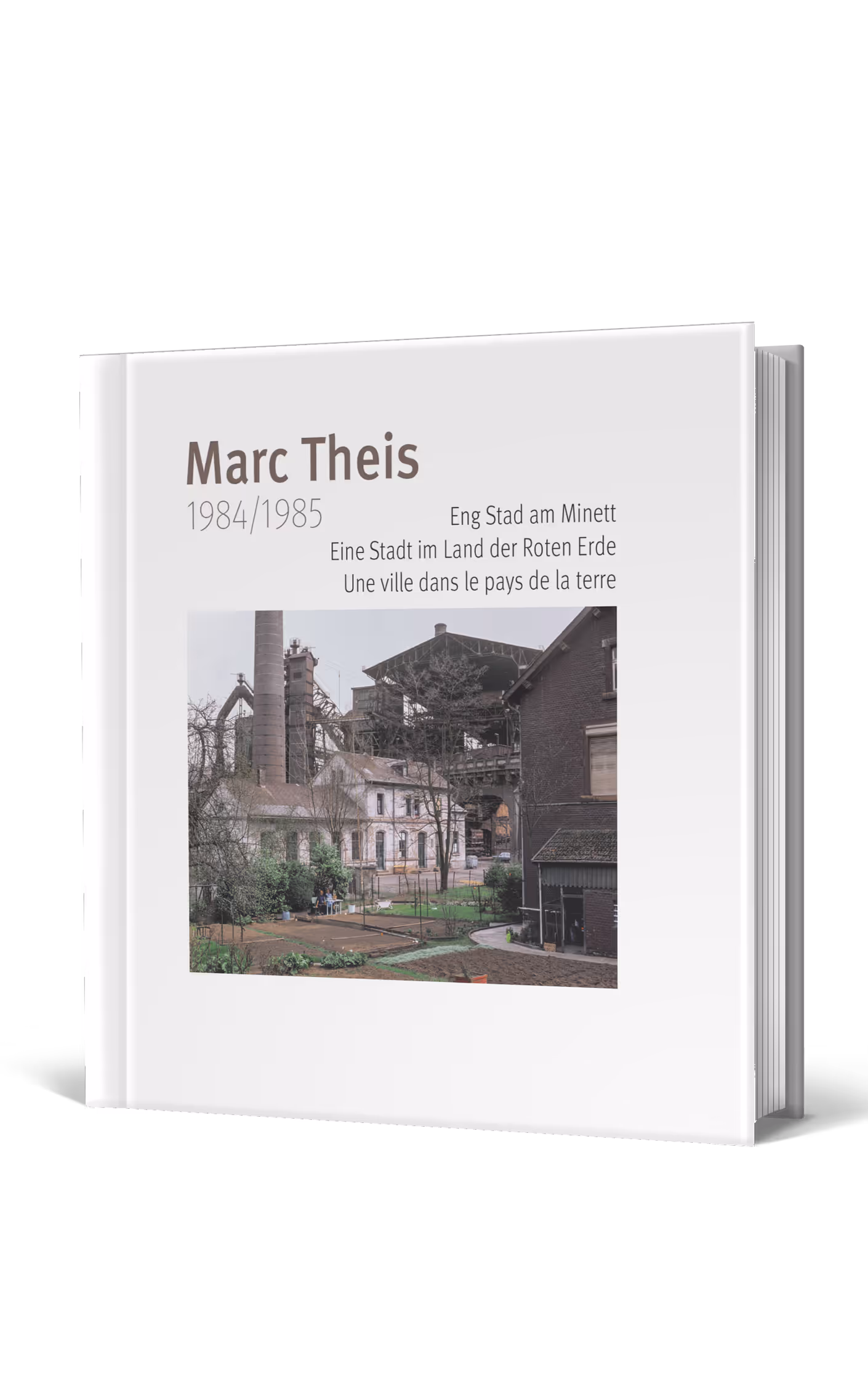 Book cover titled 'Marc Theis 1984/1985' featuring an industrial scene with old factory buildings and a garden area.