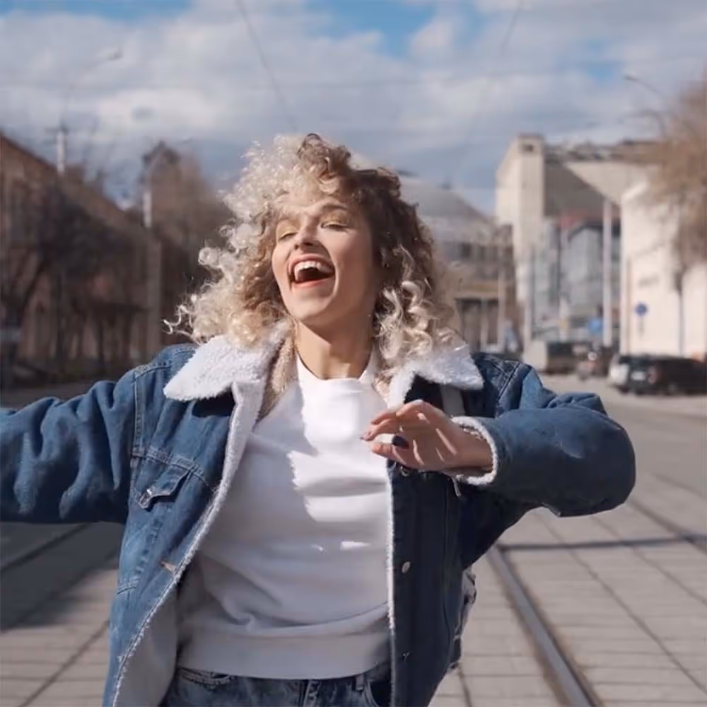 a happy girl dancing down the street