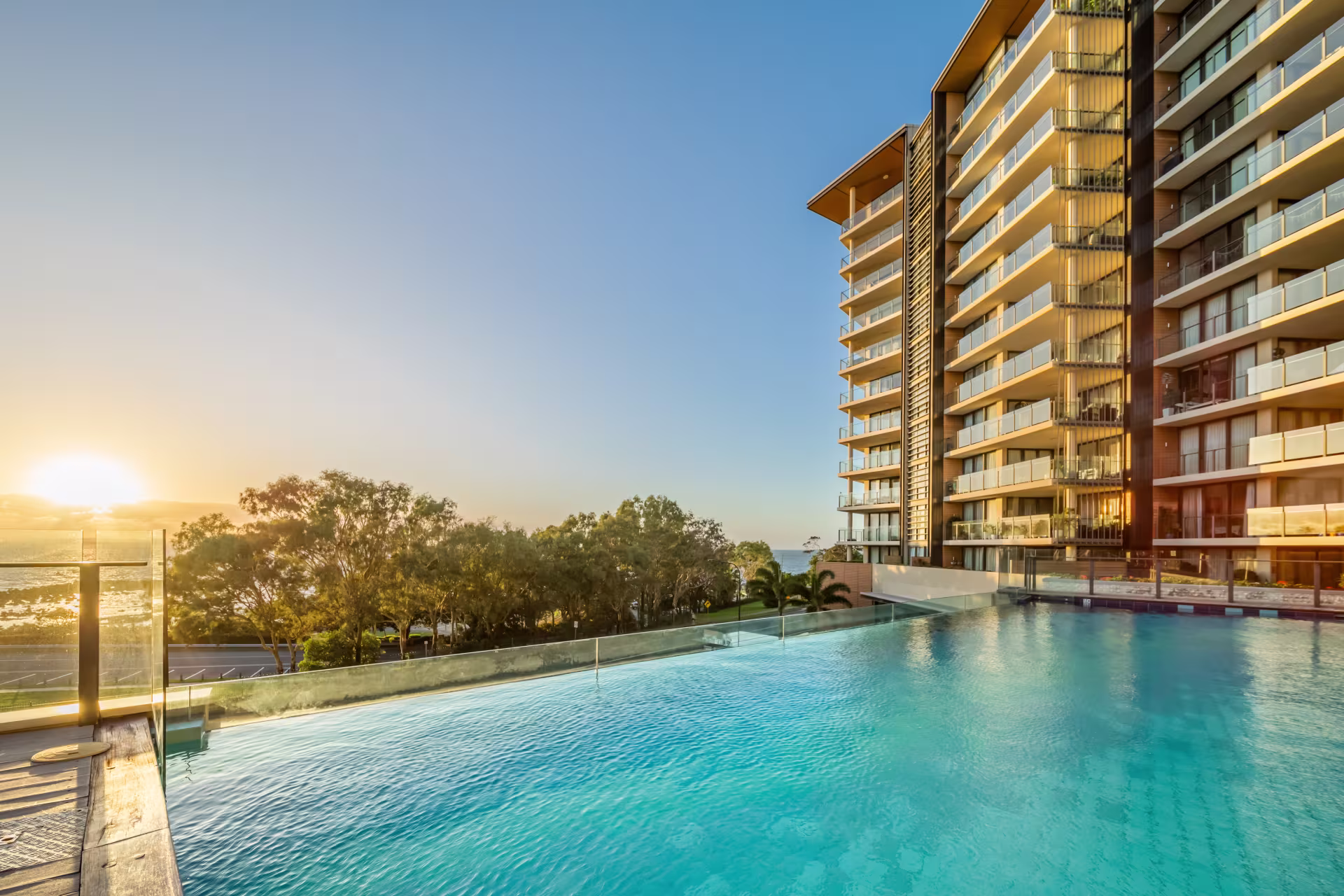 Poolside deck and lounge area at Oaks Redcliffe Mon Komo Suites