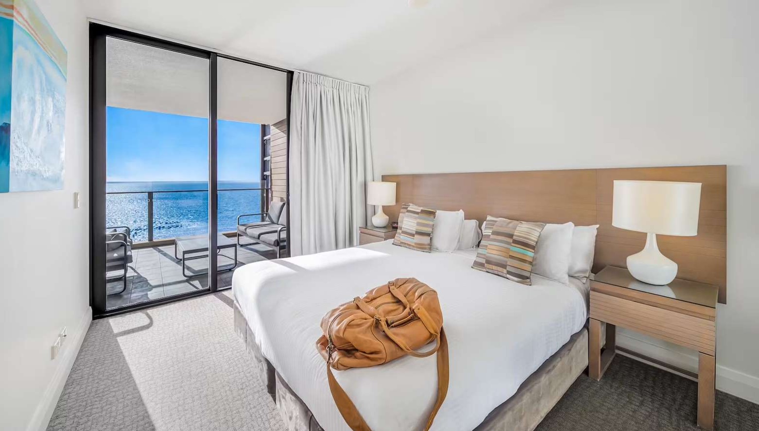 Suite bedroom with balcony doors opening onto Moreton Bay views