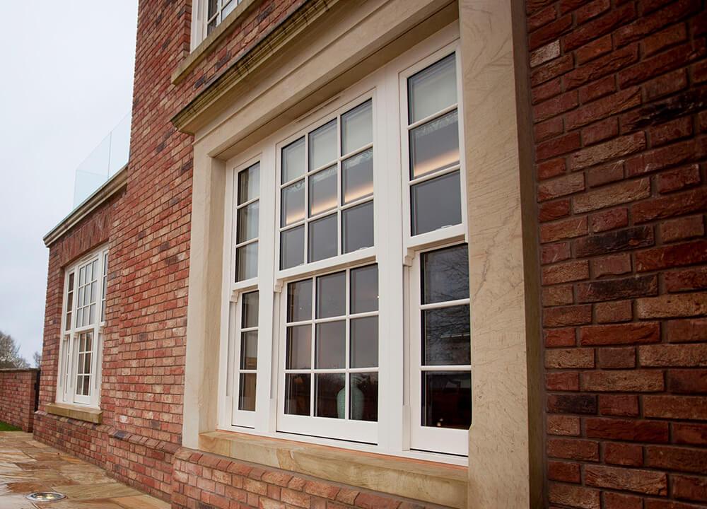 Victorian-style uPVC sliding sash window with run-through sash horns