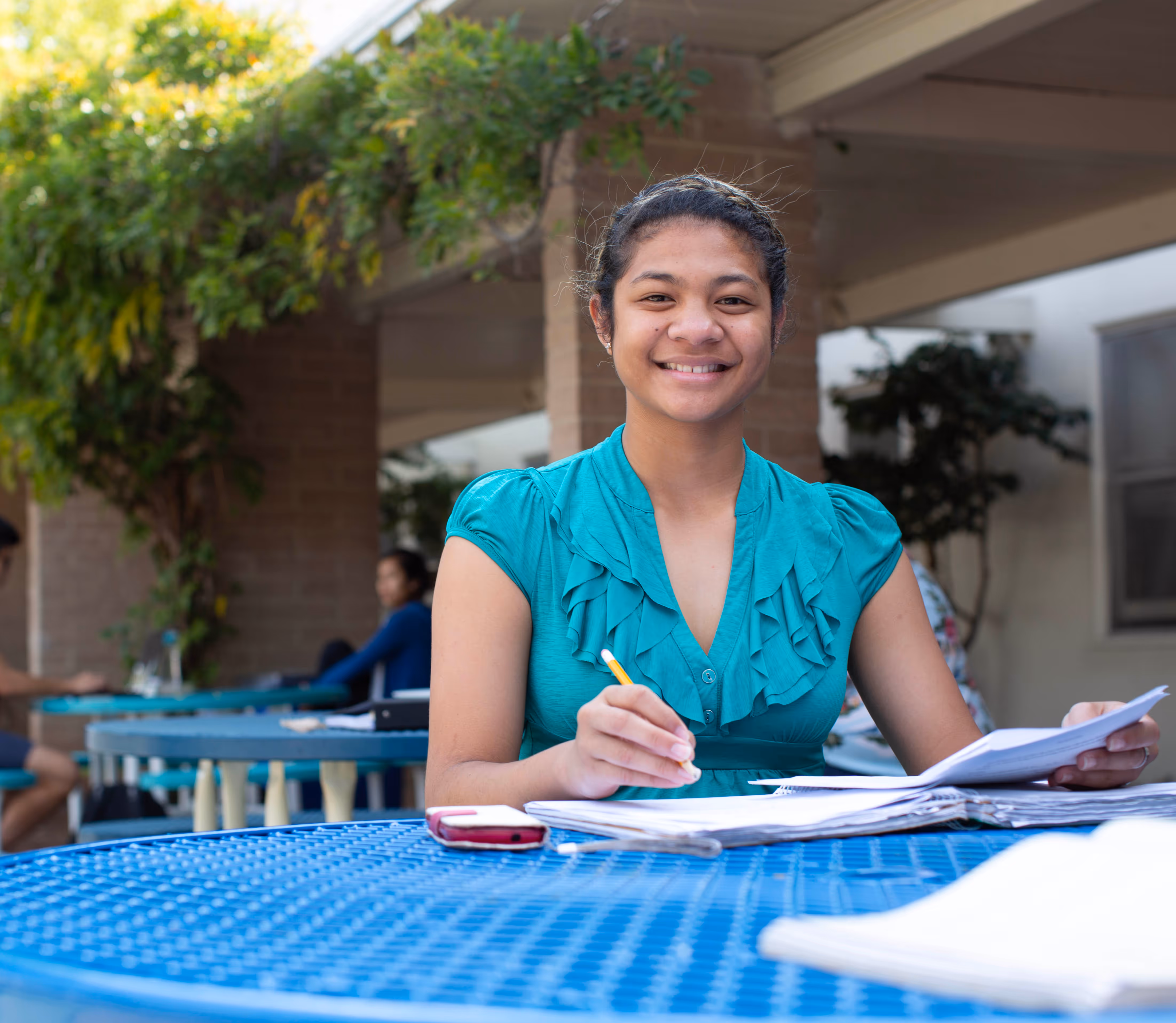 Woman sits at table and completes school work
