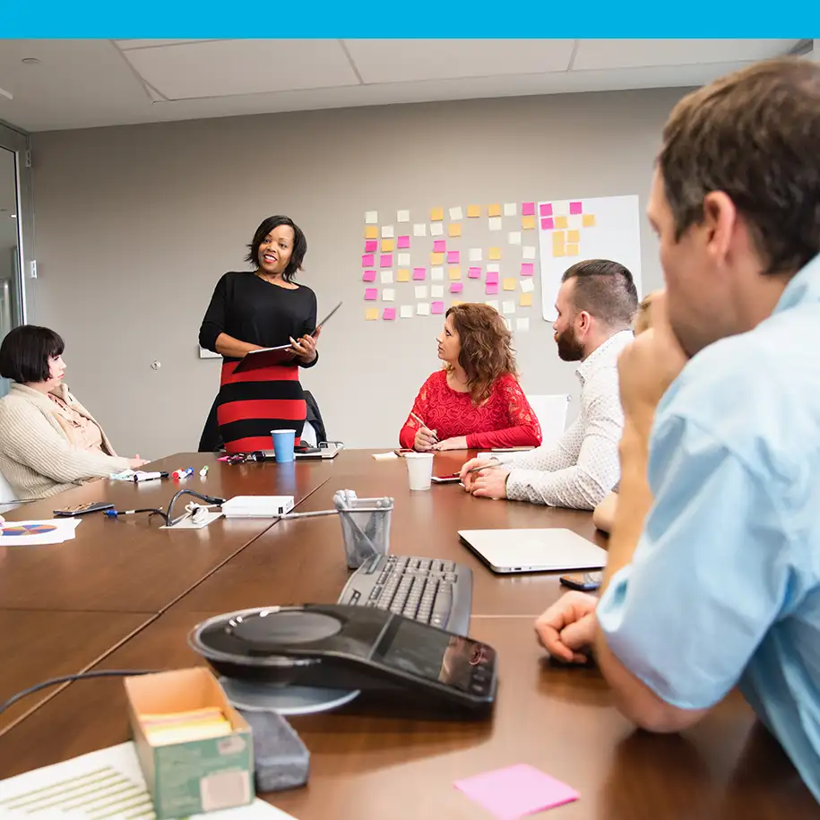 Student staff speak around a table | InsideTrack