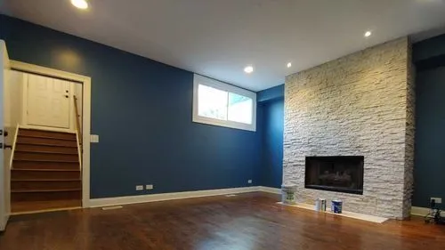 A photograph of a living room with wood floors