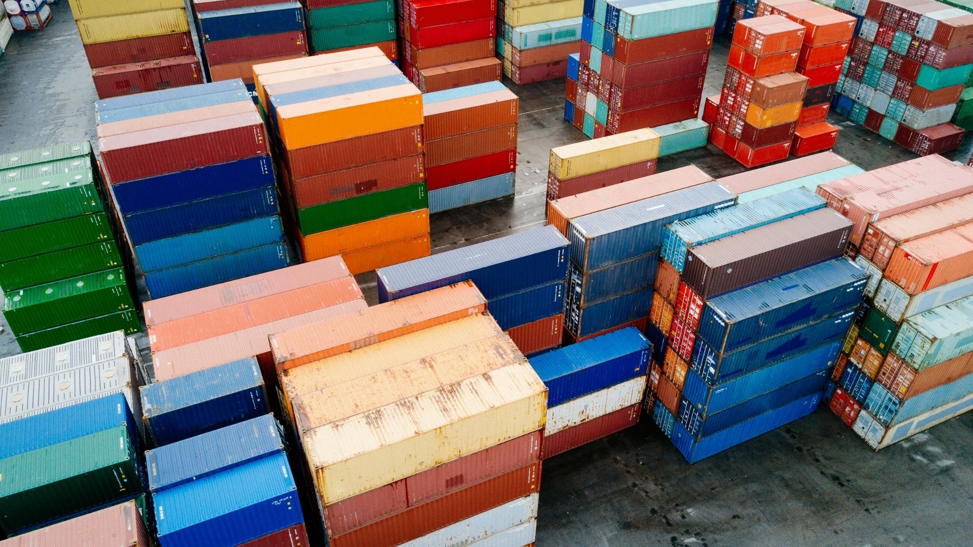 A stack on containers at a terminal with bill of lading and container numbers