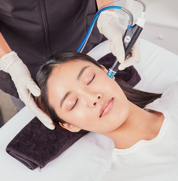 Doctor performing facial assessment and analysing skin quality during aesthetic consultation