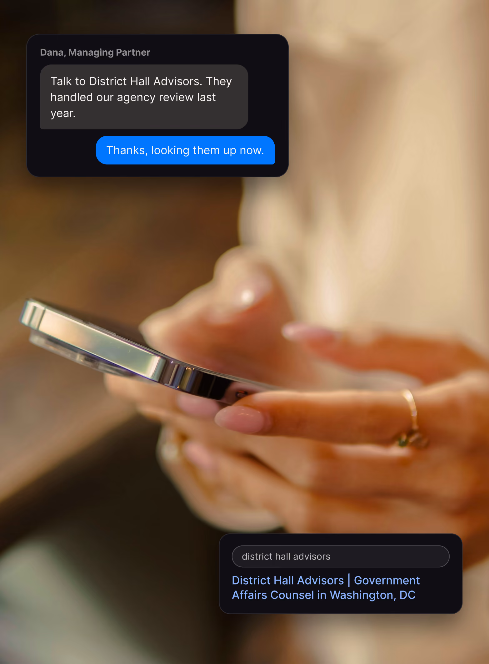 Office photo: Professional in an office checking a firm’s website on their phone