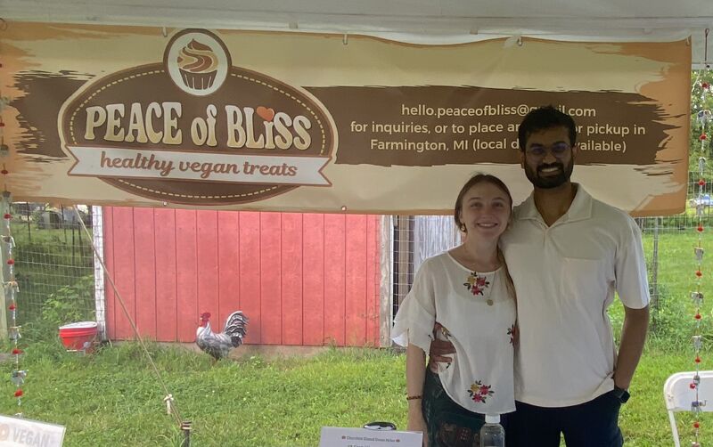 Angela and partner at Peace of Bliss vegan treat stand in market