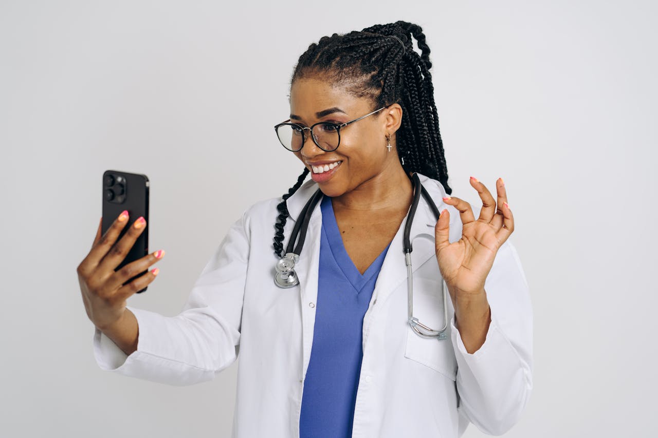 black woman doctor taking a selfie with a smartphone