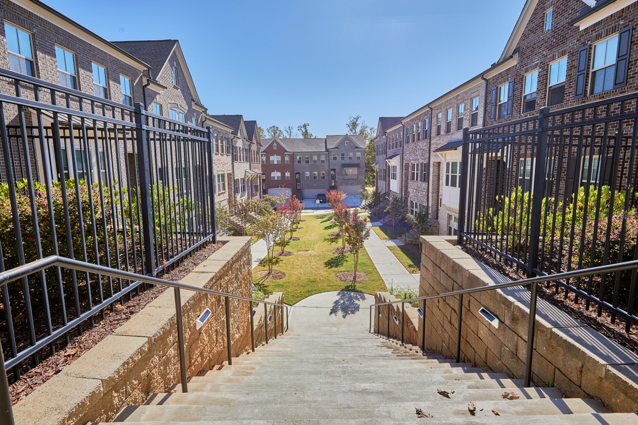 Stairway and landscaped courtyard between residential buildings at Sienna Apartments.