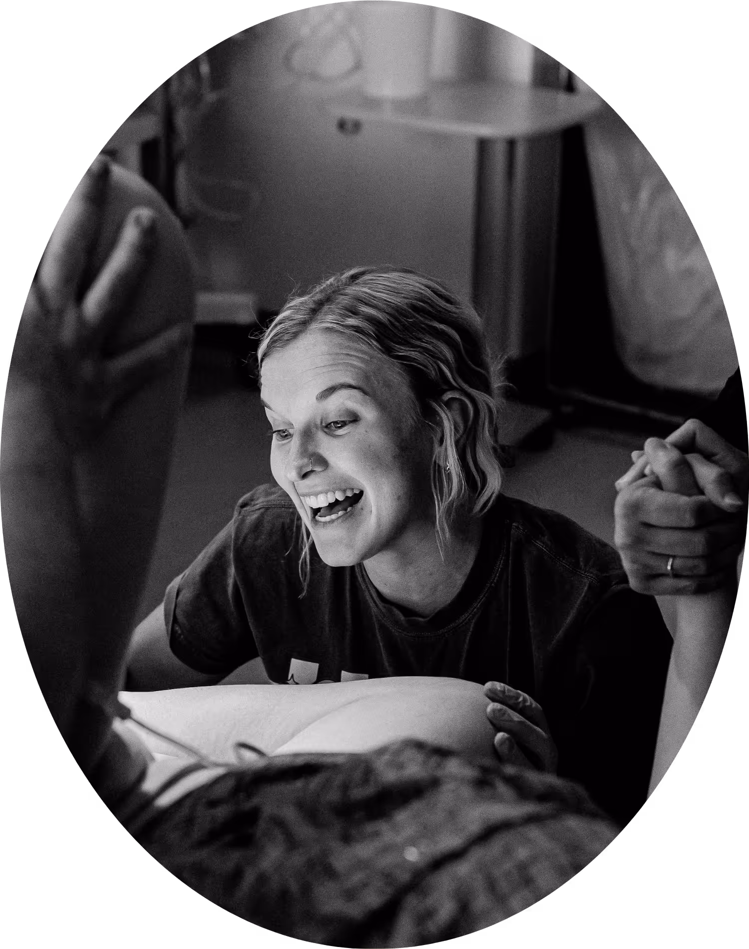 Labor and delivery RN smiling watching the crowning of a baby.