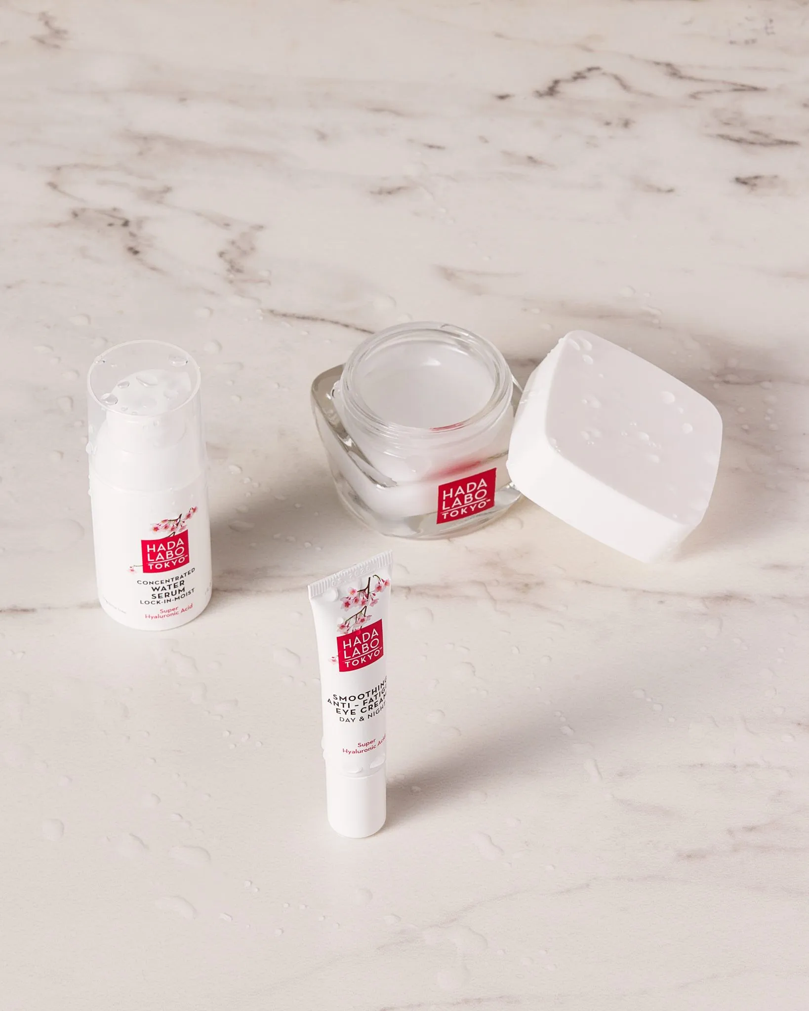Hada Labo white range skincare products on a marble countertop