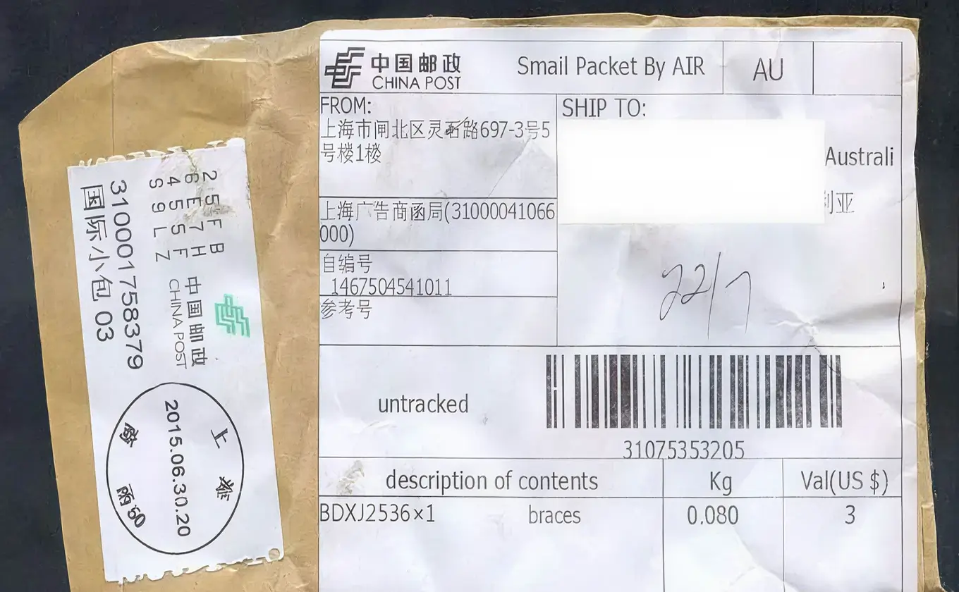 China Post air mail package label showing sender from Shanghai and recipient in Australia with braces inside.