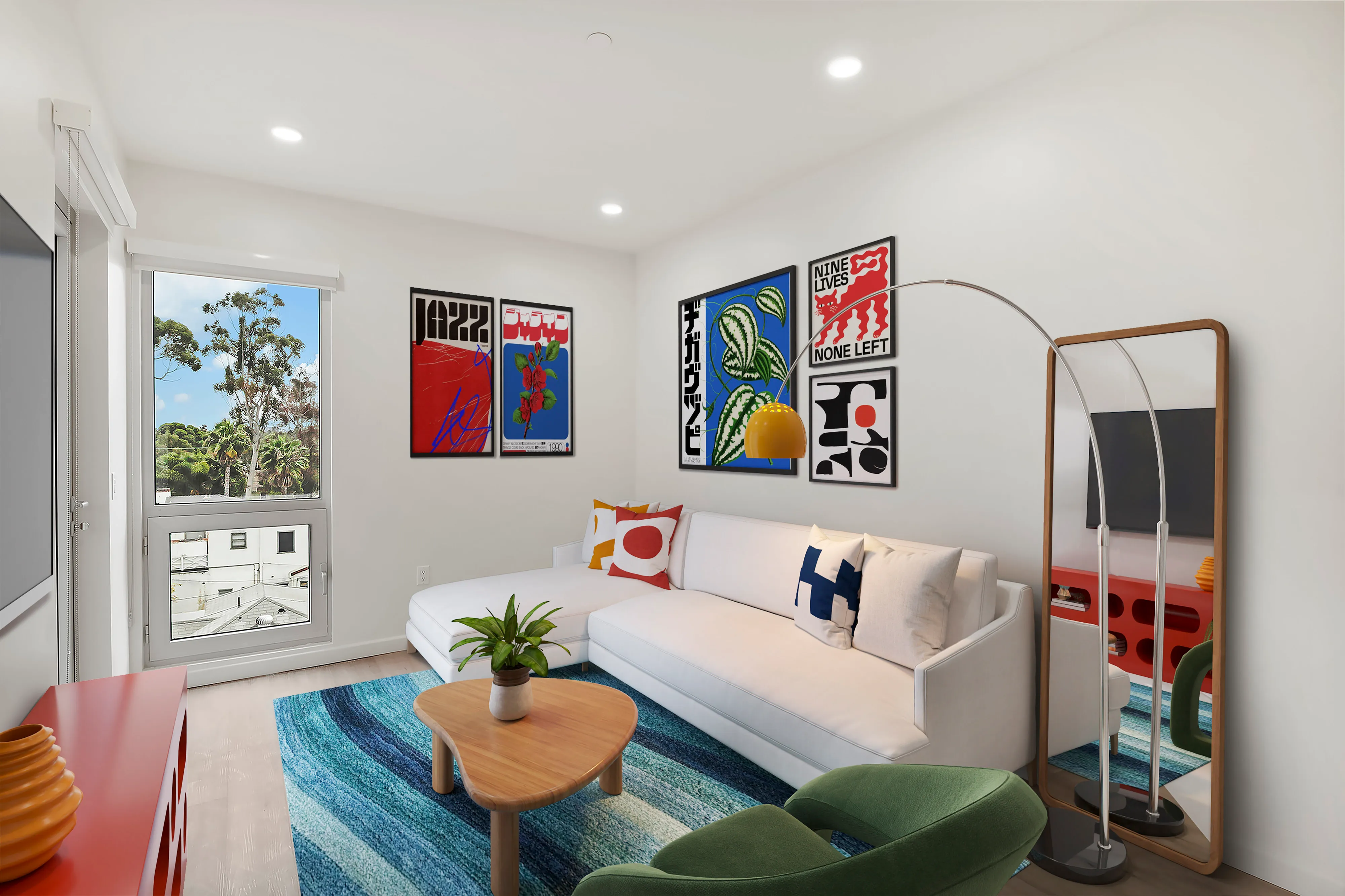 Modern living room with white sectional sofa, colorful pillows, green chair, wood coffee table, blue rug.