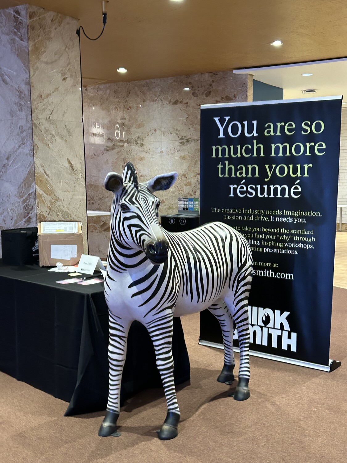 A 5-foot zebra statue in front of Robert Smith's booth at DesignThinkers 2024
