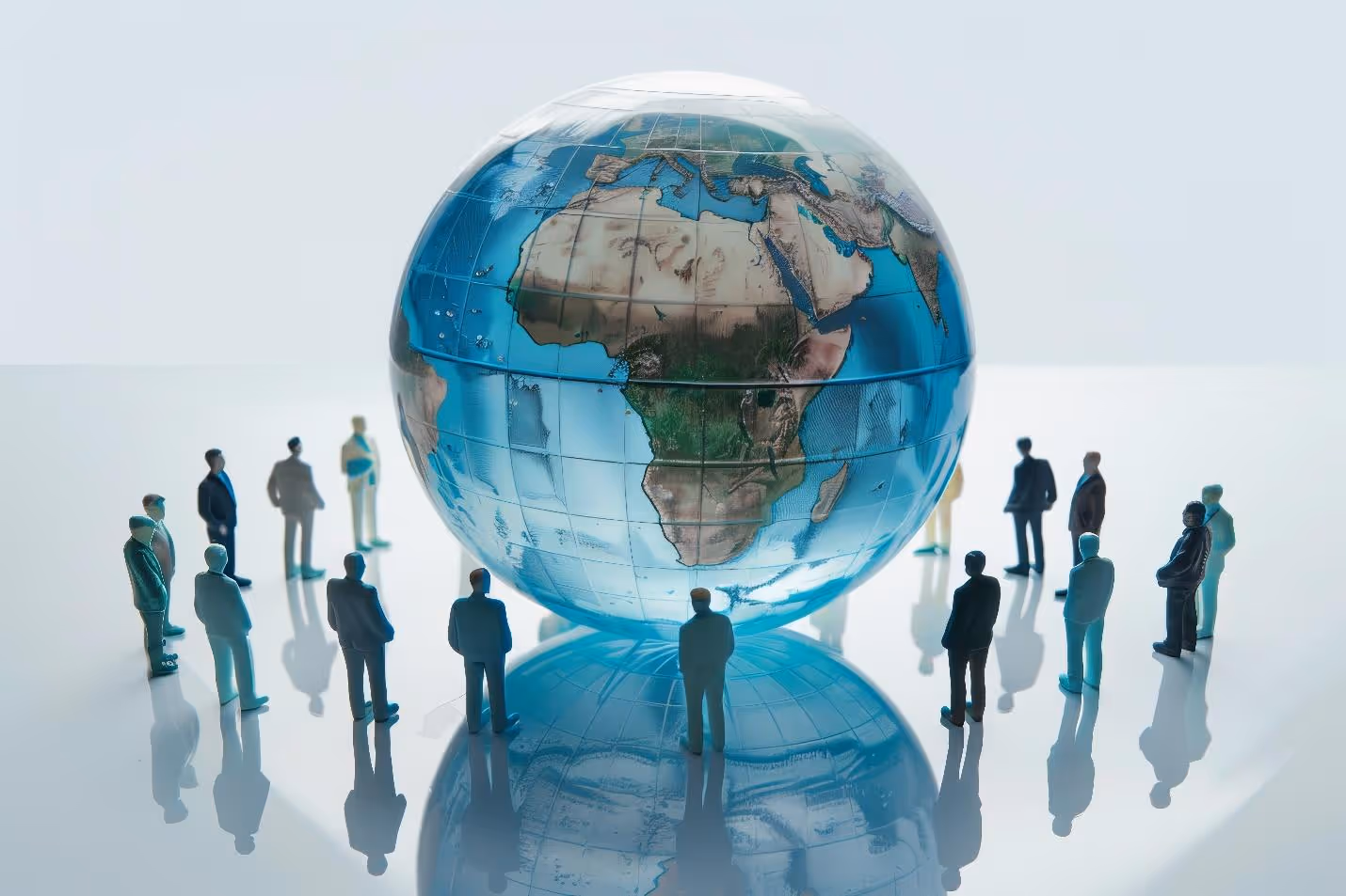 A group of miniature people standing around a globeAI-generated content may be incorrect.