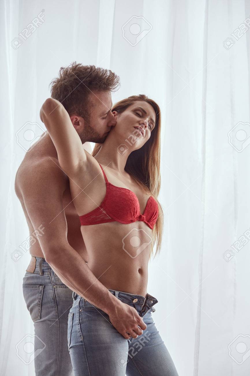 Topless man unbuttoning woman's jeans during foreplay - 81578283