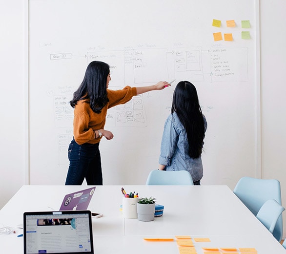 picture of a woman leading a design team in a meeting