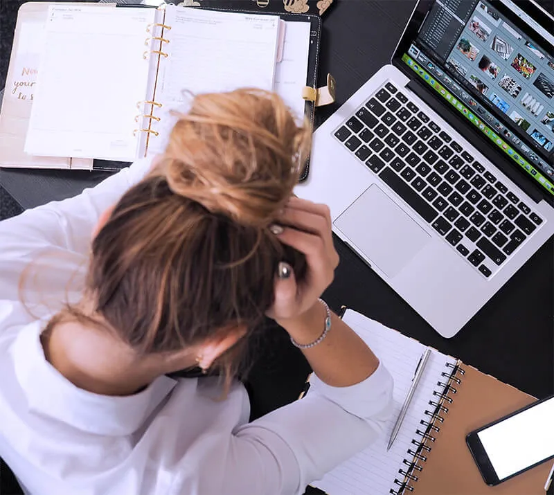 A life coach, struggling to build her own website and holding her head in frustration.