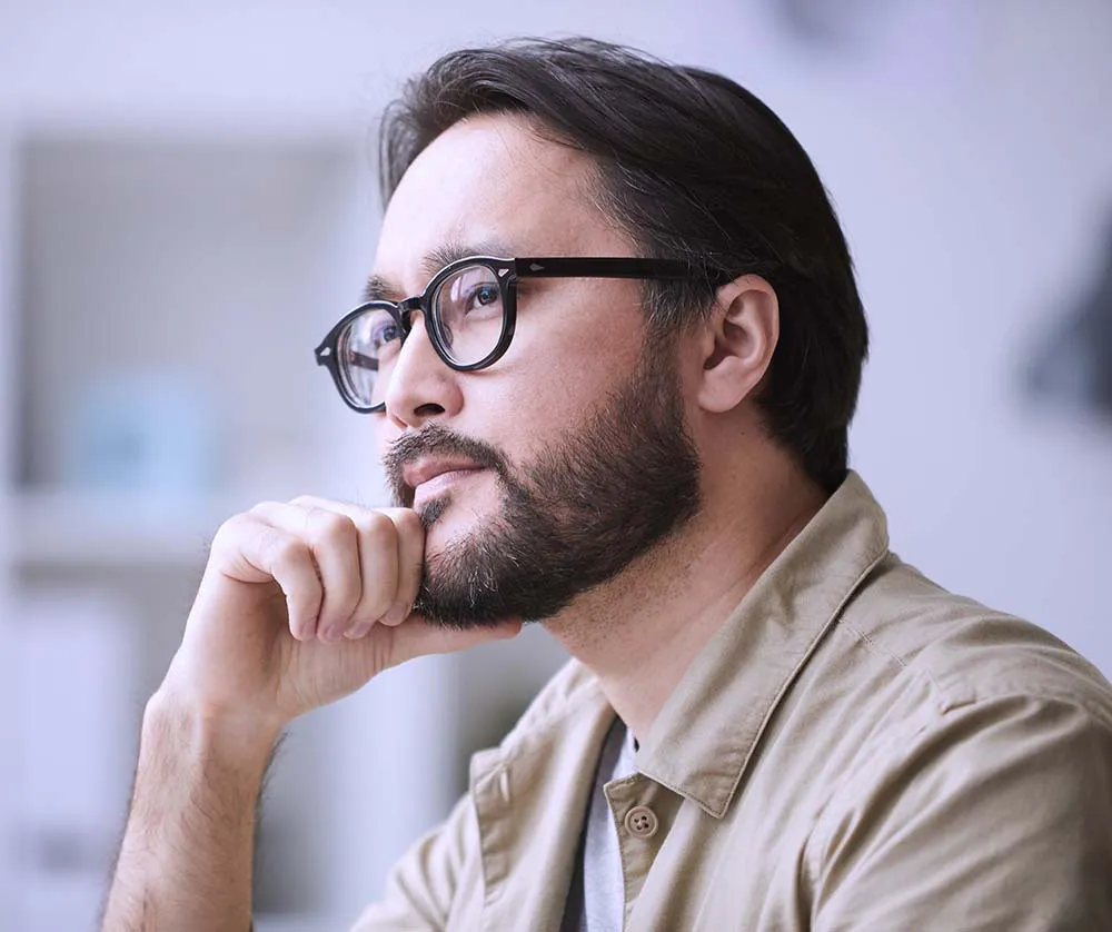 Stressed therapist daydreaming about all of the things he has to learn to build his own website