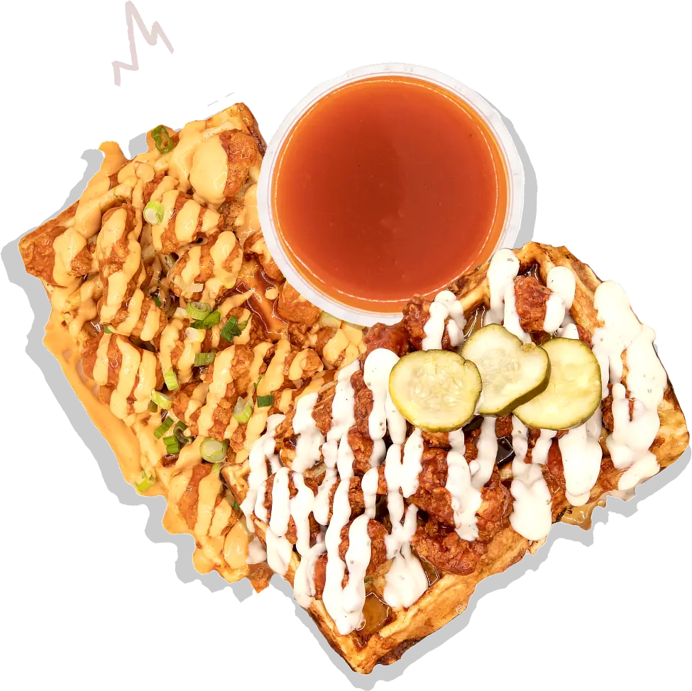 A waffle with sauce and cucumbers on it.