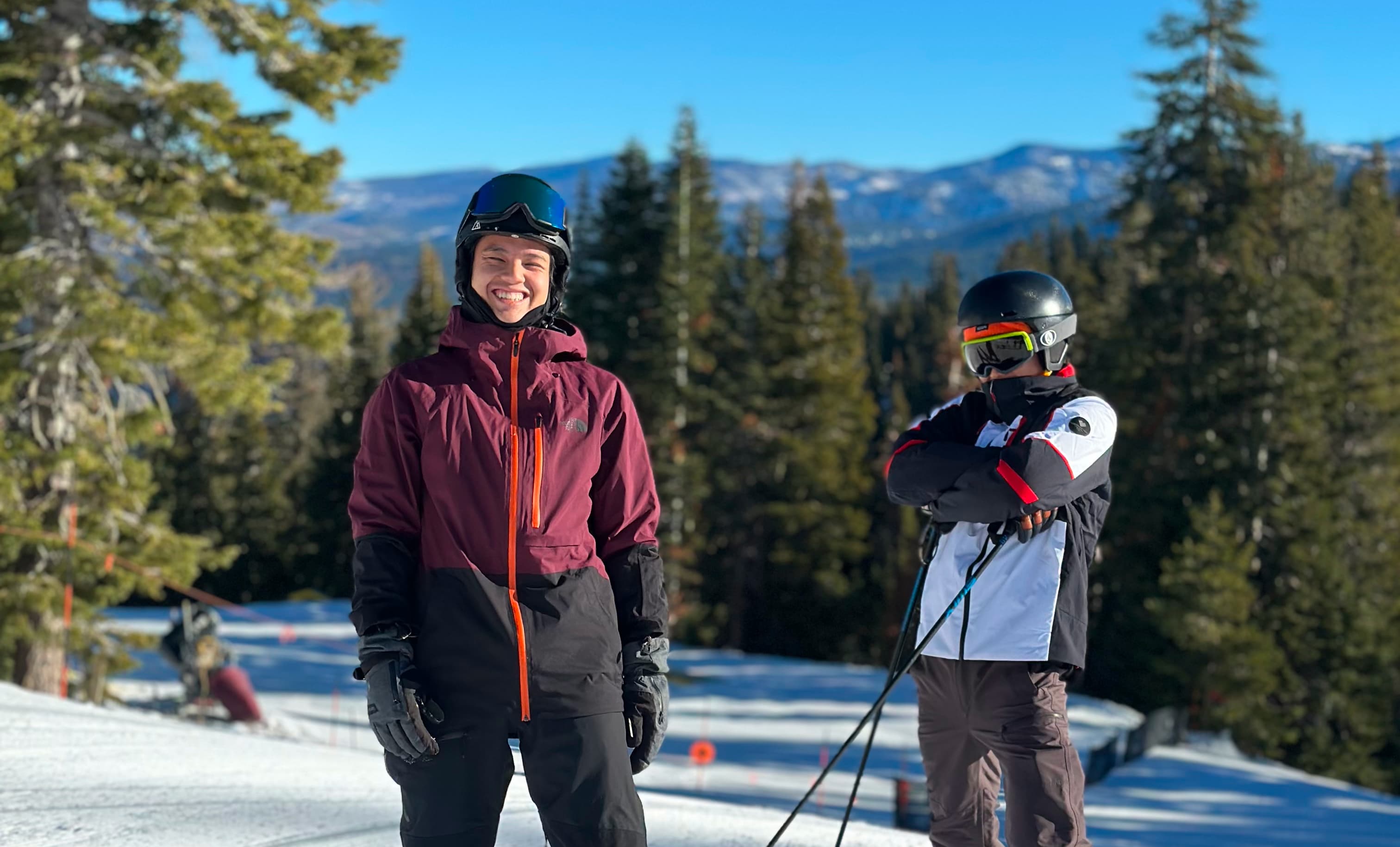 Santiago and his brother posing on a mountain before skiing down