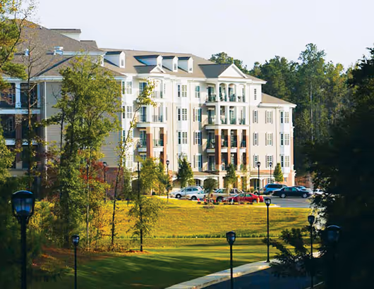 spring harbor senior living community amongst trees and green grass