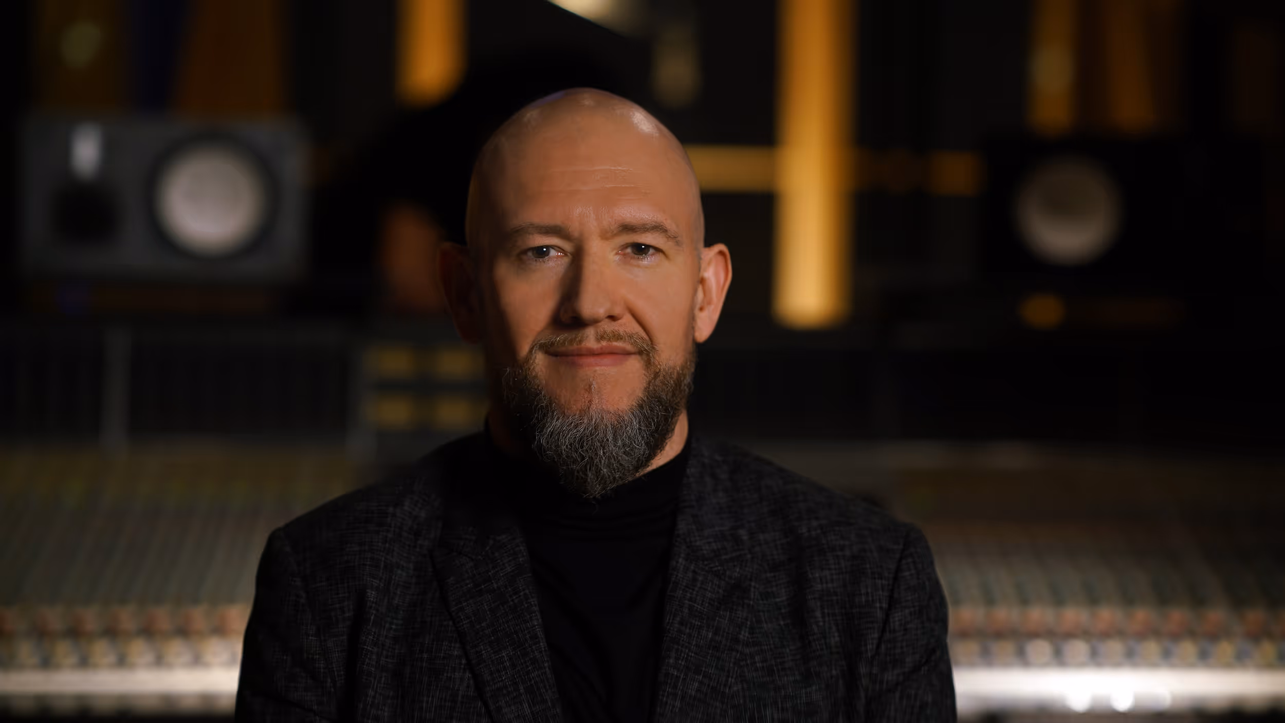 A man with a beard and a black shirt.