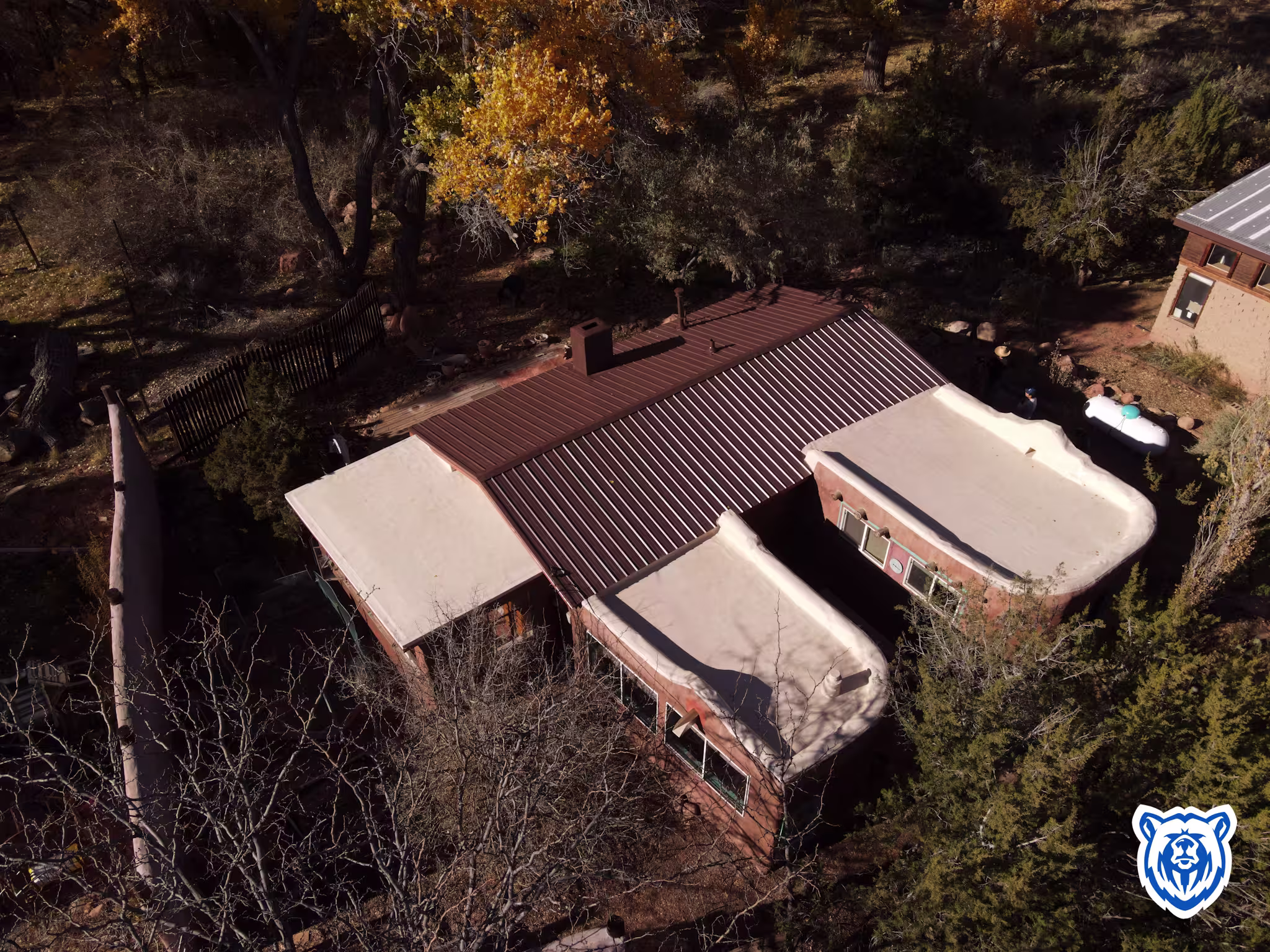 Roof replacement where pitched areas have metal panels, flat areas are TPO