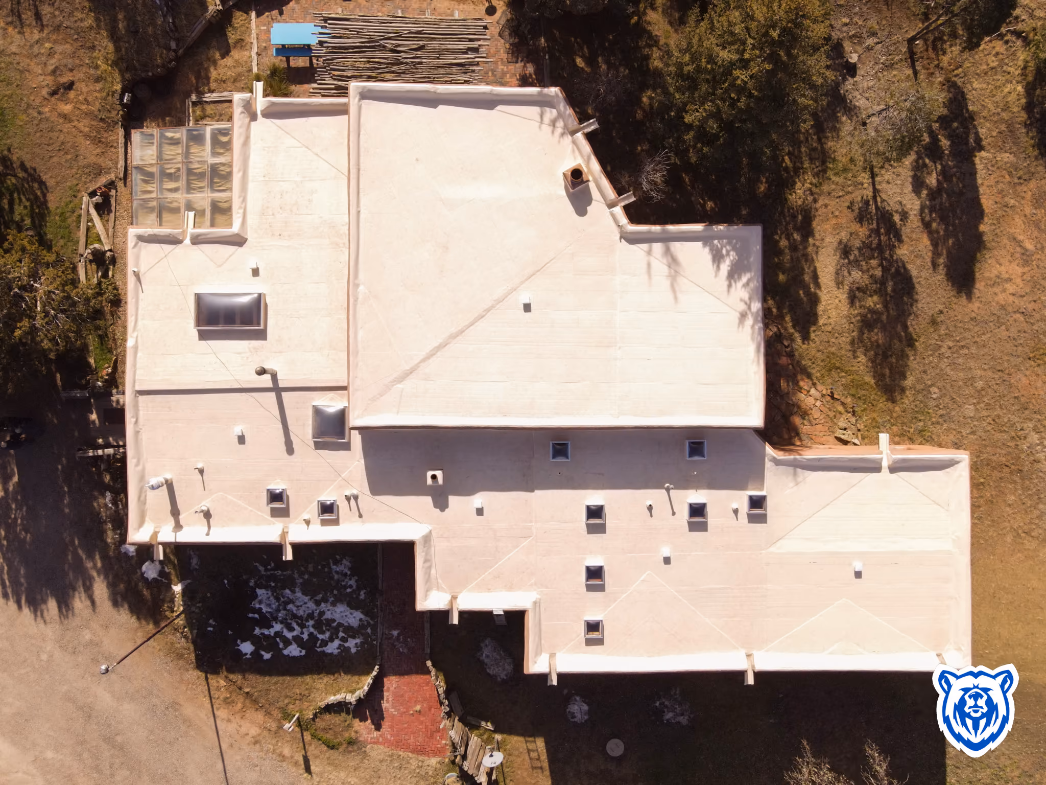 A tan flat TPO roof installed by Blue Bear Roofing in Sandia Park, NM