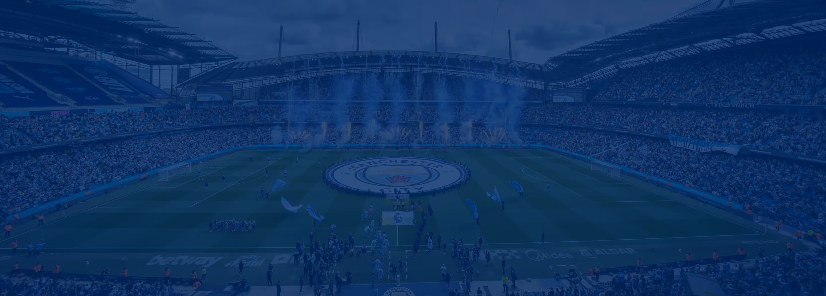 Full stadium at Etihad Stadium with crowd and fireworks as players prepare for a Manchester City football match.