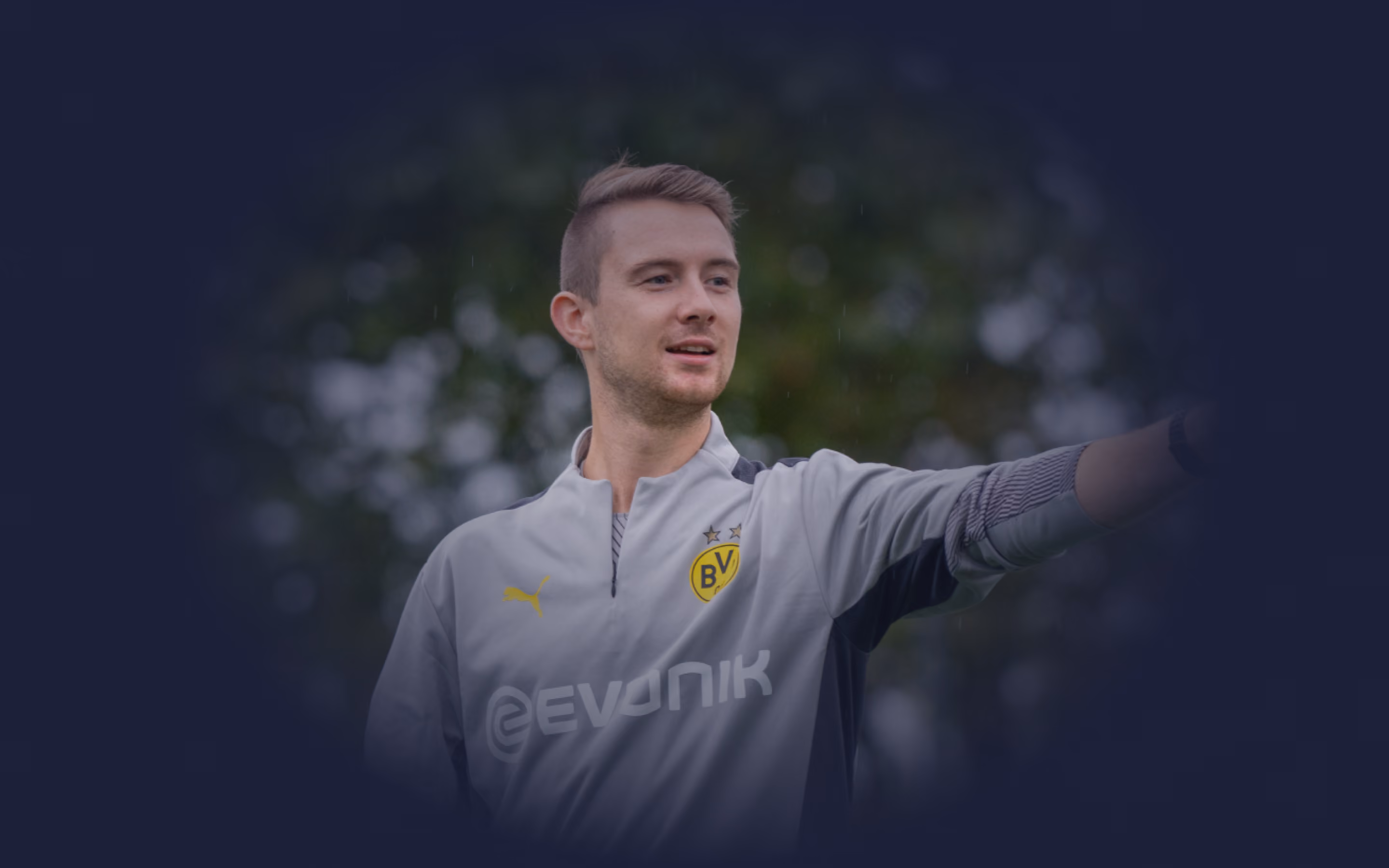 Coach in a grey Borussia Dortmund training jacket pointing and giving instructions