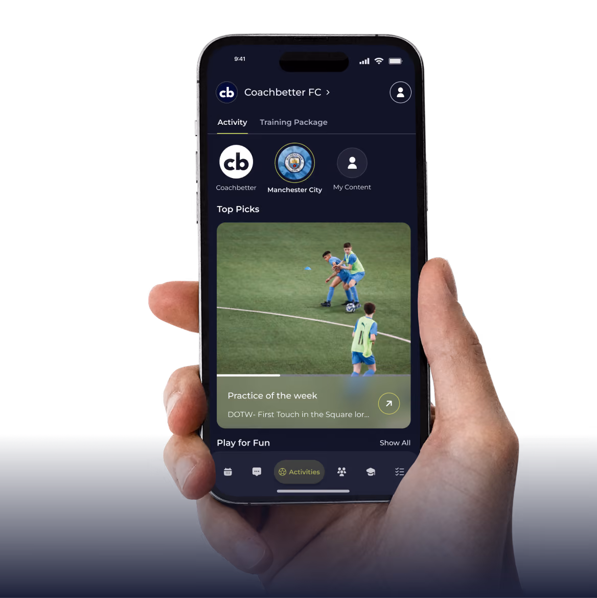 Hand holding phone showing a soccer training app with kids playing on a green field.
