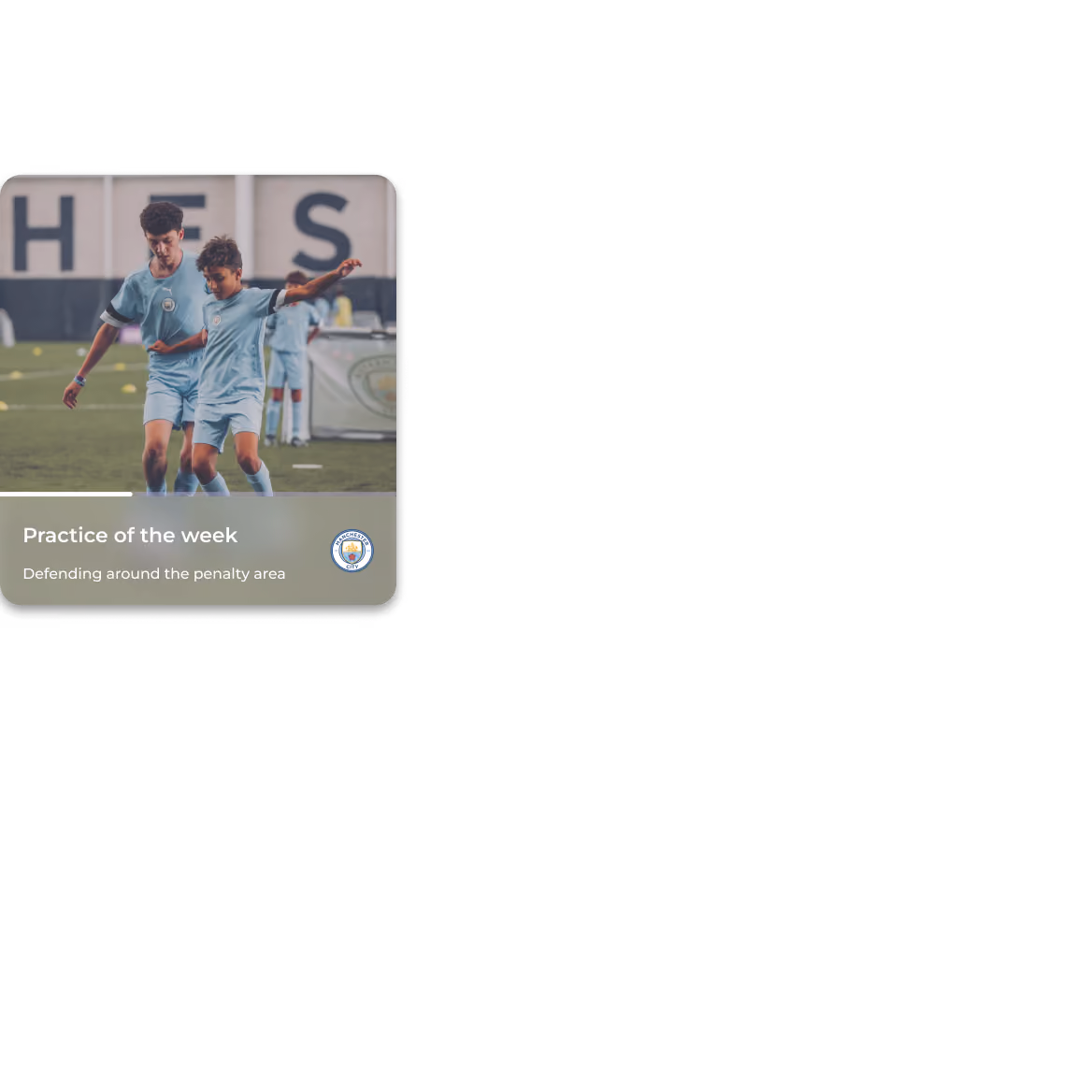 Two young soccer players in blue Manchester City kits practicing defending on a field.