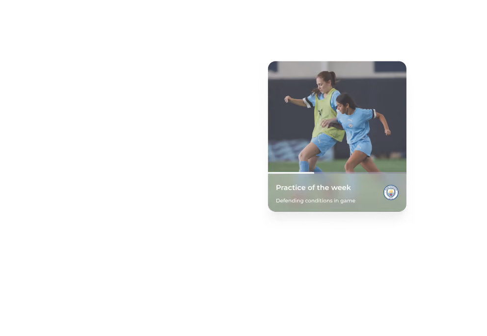 Two female soccer players contesting the ball during practice on the field.