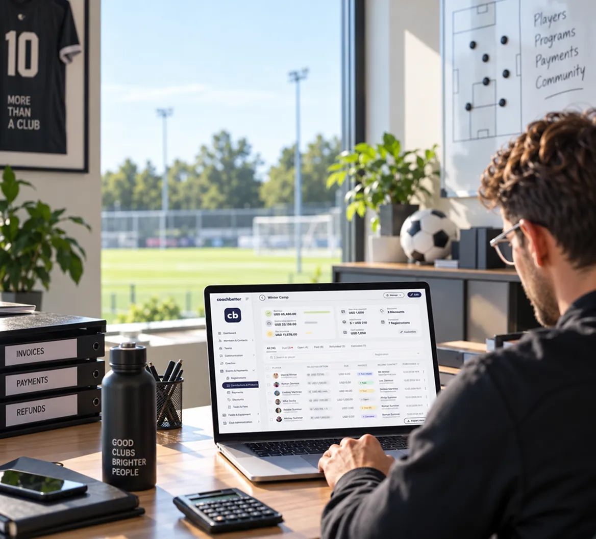 Club manager using the Coachbetter dashboard on a laptop in an office next to a football pitch