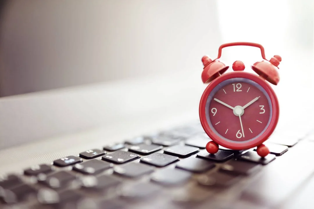 Alarm clock on laptop concept for business deadline