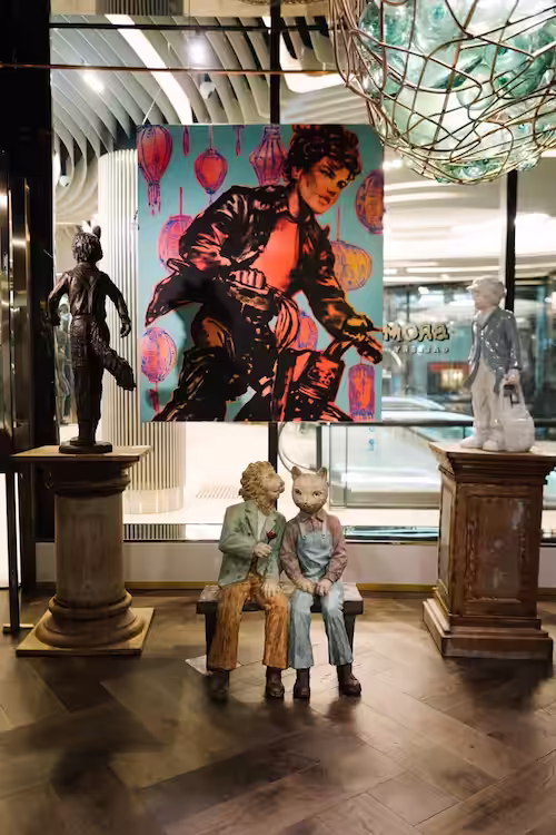 David Bromleys sculptures in front of one of his paintings