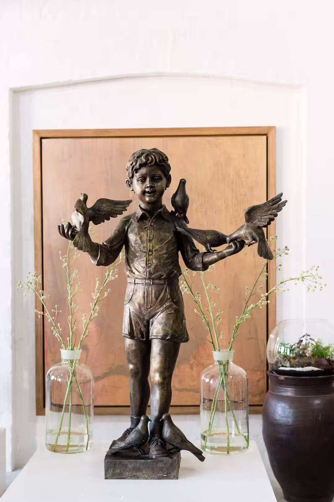 Boy with birds on his shoulders sculpture by David Bromley