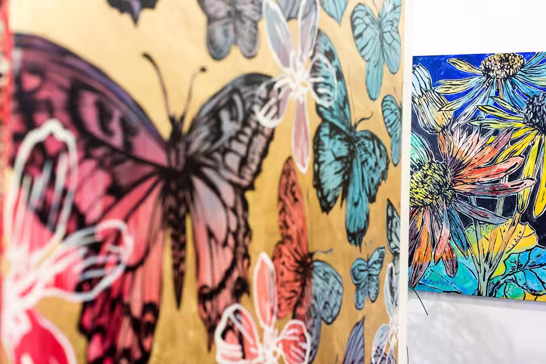 Photograph of David Bromley butterflyPaintings on a wall.