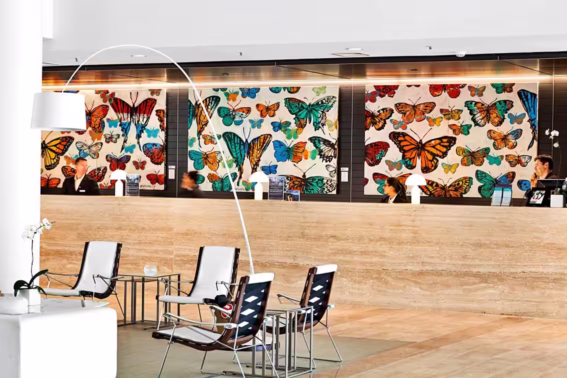 Sheraton Mirage Interior project by David Bromley. Lobby room with Paintings by David Bromley on the wall behind a reception.