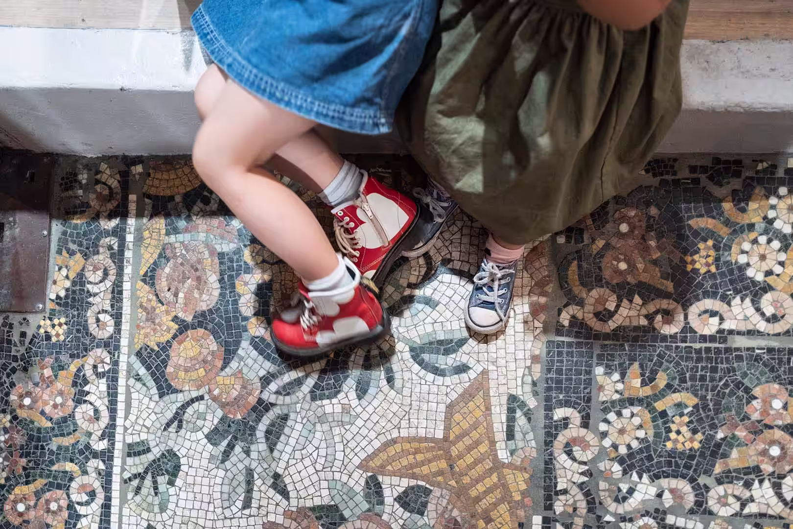Childrens feet on ornate floor